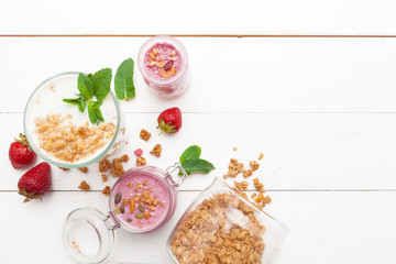 Strawberry with yogurt on white rustic wooden background. Cream dessert