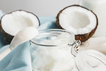 Organic healthy coconut butter and fresh coconut pieces on wooden board