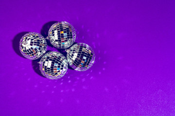 disco ball shines on purple background close up