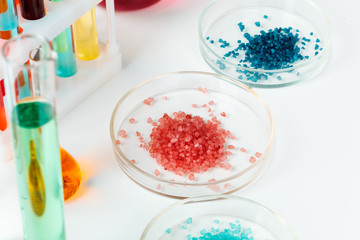 Obraz na płótnie Canvas Colored liquids inside lab glassware on white table in laboratory