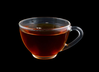 Glass cup of tea isolated on black