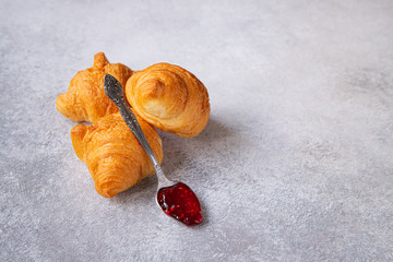 Fototapeta na wymiar french homemade little croissants with raspberry marmalade