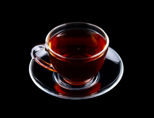 Glass cup of tea isolated on black