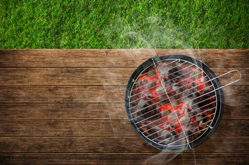 Burning barbecue on grass background