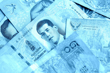 Various banknotes thai baht close up. Money background blue color toned