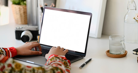 Woman using laptop on white workspace table