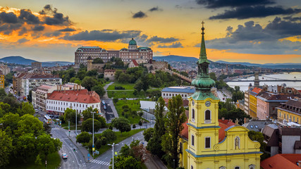 Fototapeta na wymiar Budapest, Hungary - Aerial skyline view of Budapest with Saint Catherine of Alexandria Church, Buda Castle Royal Palace and Szechenyi Chain Bridge with a beautiful golden sunset at summer time