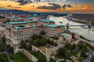 Fototapeta na wymiar Budapest, Hungary - Aerial skyline view of Buda Castle Royal Palace with Szechenyi Chain Bridge, Matthias Church and Parliament building with a beautiful golden sunset at summer time