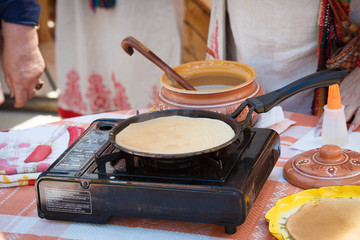 Cooking pancakes. Frying pancakes in a pan on a gas stove. Russian pancake.