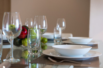 Table served for dinner with cutlery and fruit close-up.