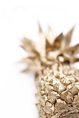 Gold painted pineapple element on white background