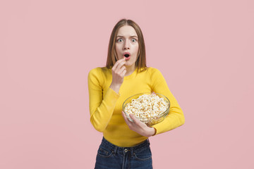 Surprised girl eating pop corn