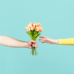 Hand offering flower bouquet