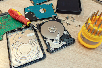old broken hard disk drives composition in a repair recovery service concept close up selective...