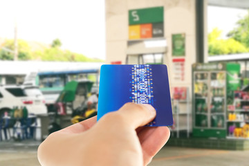 Credit card with mobile phone to make a payment for refueling car on gas station