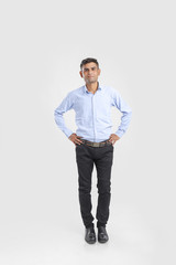 young indian man Standing over white background