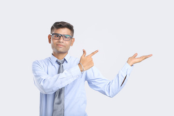 Young Indian Man Showing Direction With Hand