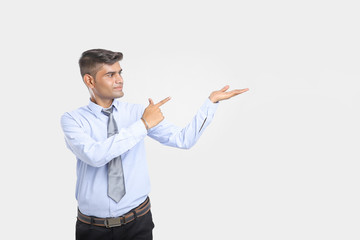 Young Indian Man Showing Direction With Hand