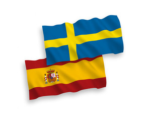 National vector fabric wave flags of Sweden and Spain isolated on white background. 1 to 2 proportion.