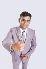 Young Indian Man Wearing suit and showing thumps up 