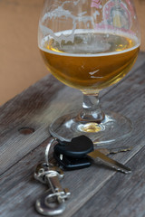 Drinking and driving - Vehicle keys near a glass beer