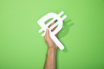 cropped view of man holding white peso currency sign on green - obrazy, fototapety, plakaty