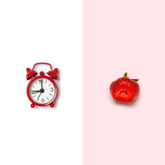 Creative picture of red alarm clock and red strawberry