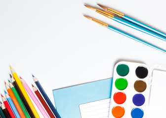 Different school supplies on white table background. Place for text.