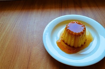 jelly dessert based on milk with caramel syrup on a plate
