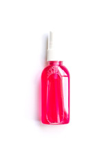 pink liquid in a small bottle on a white background
