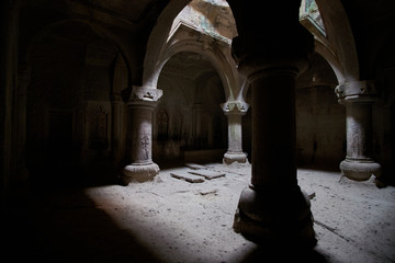 The columns of the ancient temple, illuminated through the windows, are carved with religious symbols on the walls.