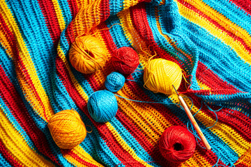 Multi-colored striped crochet, crochet hook and yarn.