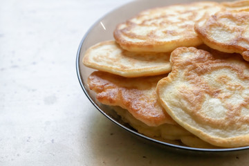 fresh pancakes on a glass dish. authentic homemade food. background backdrop.