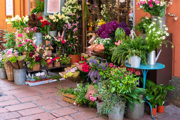 Fototapeta na wymiar A variety of flowers on a street exhibition flower shop. Bologna, Italy.