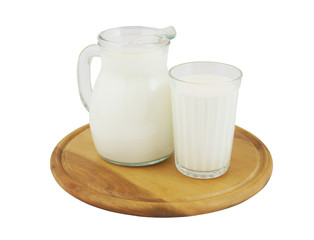 Jar of milk and glass on cutting board isolated on white