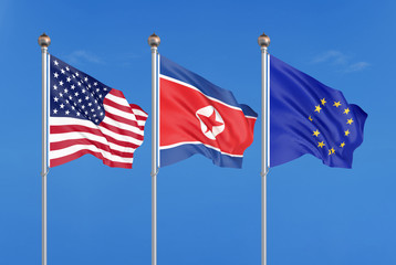 Three colored silky flags in the wind: USA (United States of America), EU (European Union) and North Korea. 3D illustration.