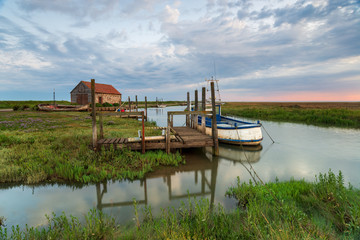 Fototapeta premium Dawn over the old harbour at Thornham