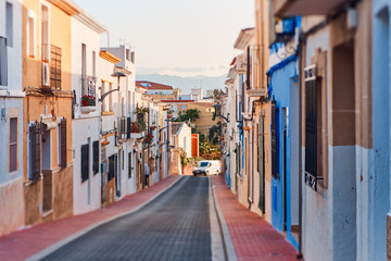 Old town of Denia with narrow streets and coloured houses.