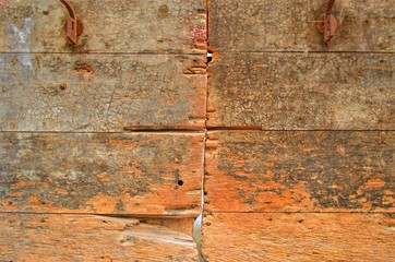 fragment of a very old wooden door with cracks and potholes