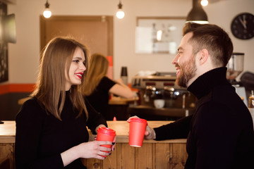 Young attractive couple on date in coffee shop.