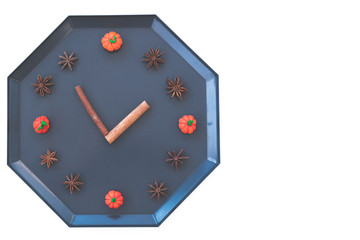 autumn fall flat lay, top view arrangement, clock made of natural materials pumpkin, cinnamon sticks, walnuts, star anise on white background, flat lay, top view