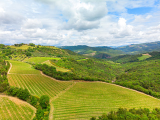 Aerial view of a vineyard and hotel in the green landscape of Tuscany Italy