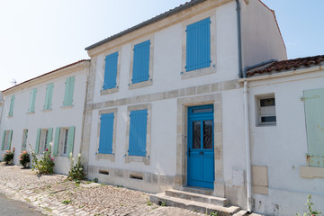 Fototapeta na wymiar ancient house white wall and colors shutter in Ile d'Aix in France island
