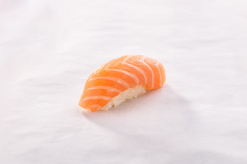 Obraz na płótnie Canvas Salmon niguiri sushi on White crumpled paper background