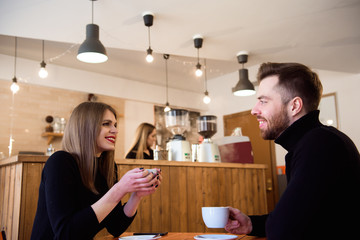 Young couple talking in a coffee shop