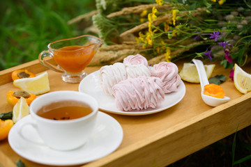 Delicious light dessert - marshmallow, fragrant tea, lemon, ginger, wild flowers