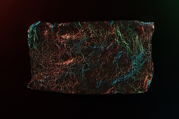 top view of glossy crumpled foil with colorful lighting reflection isolated on black