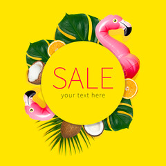 Creative concept of summer sales. Inflatable pink mini flamingo tropical palm leaf monstera coconut...
