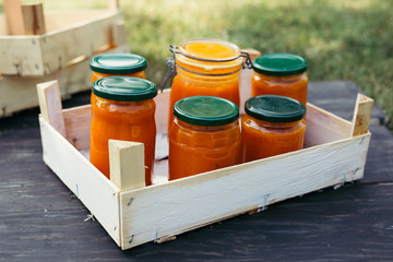 apricot jam in jars on wooden board outdoor