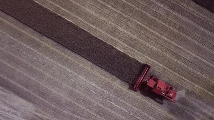 top view aerial of a harvester cropping a field
